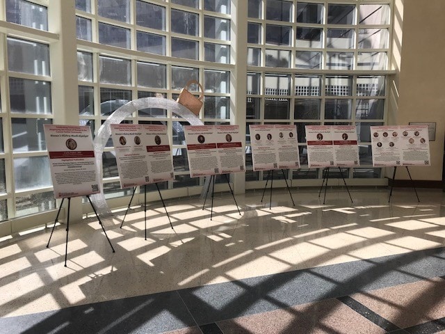 2024 IUSCCC Women's History Month highlights display — research posters on easels in the Cancer Pavilion atrium